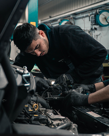 An image of a mechanic repairing and servicing a Land Rover